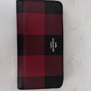 Black and red, like new, Coach wallet.